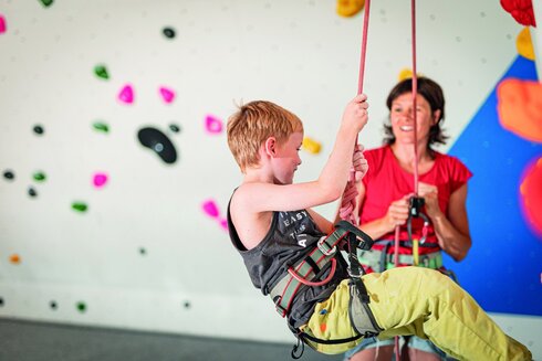 Children visibly have fun indoor climbing in the Kaunertal